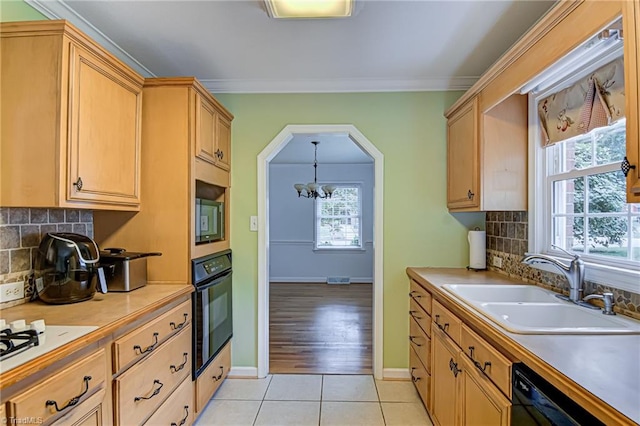 kitchen with black appliances, plenty of natural light, light hardwood / wood-style floors, and crown molding