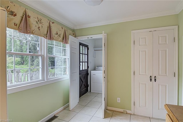 washroom with crown molding, washer / dryer, and light tile patterned flooring