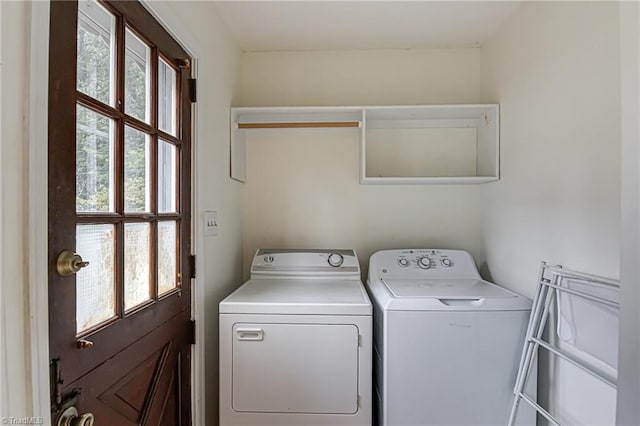 clothes washing area featuring washer and clothes dryer