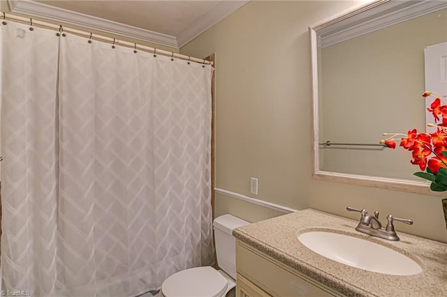 bathroom featuring vanity, toilet, ornamental molding, and walk in shower