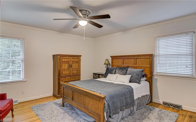 bedroom featuring crown molding, ceiling fan, and light hardwood / wood-style floors