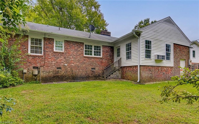 rear view of house with a yard and cooling unit