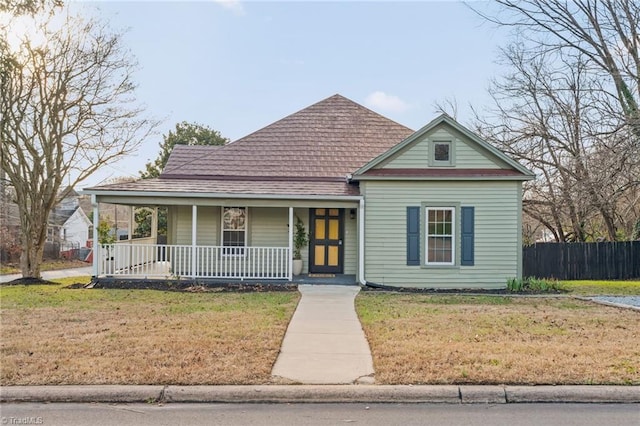 view of front facade with a front yard and a porch