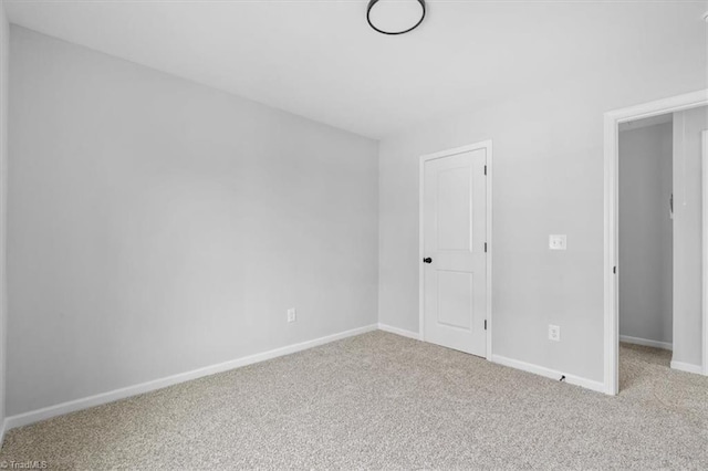 spare room featuring light carpet