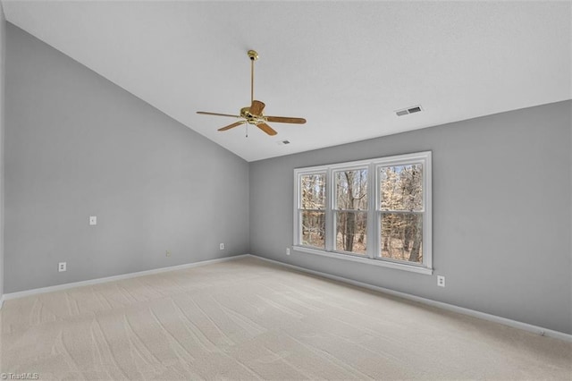 unfurnished room with light carpet, baseboards, vaulted ceiling, and a ceiling fan