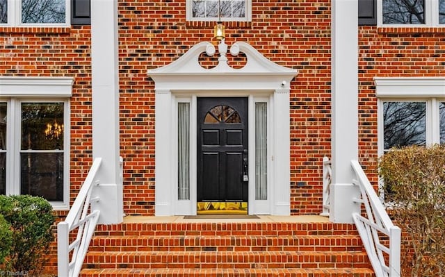 property entrance featuring brick siding