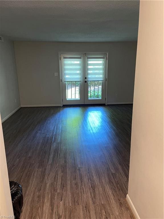 159 Turnwood Ln, Winston-Salem, NC 27104 - spare room with dark wood-style floors, french doors, and a textured ceiling