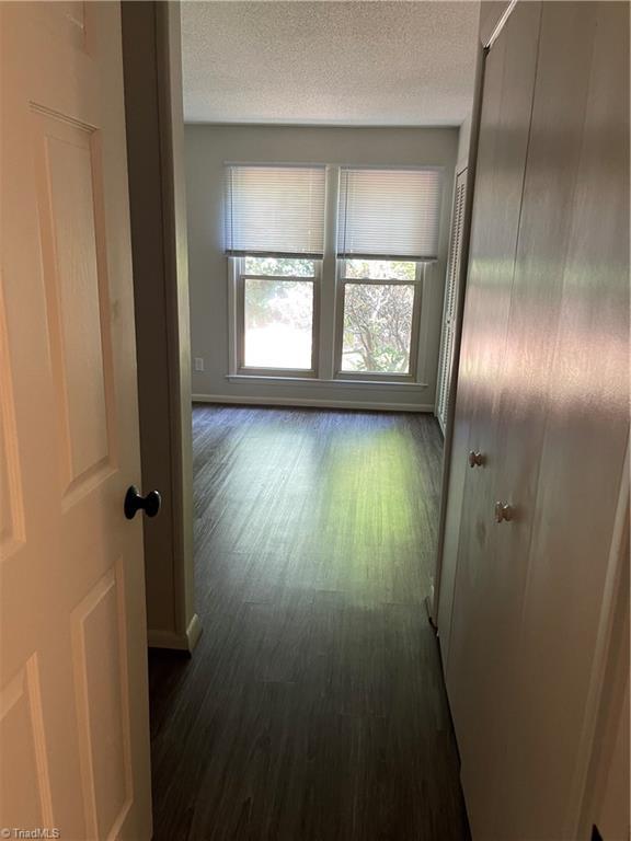 159 Turnwood Ln, Winston-Salem, NC 27104 - hall with dark wood-style floors and a textured ceiling