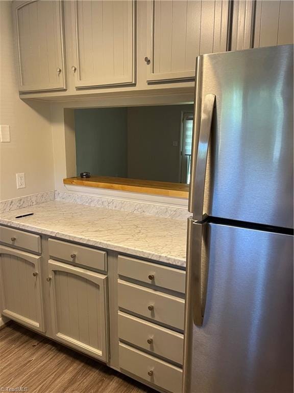 159 Turnwood Ln, Winston-Salem, NC 27104 - kitchen featuring freestanding refrigerator, wood finished floors, gray cabinetry, and light stone counters