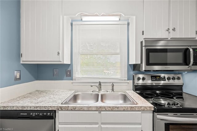 kitchen with white cabinets, sink, and stainless steel appliances