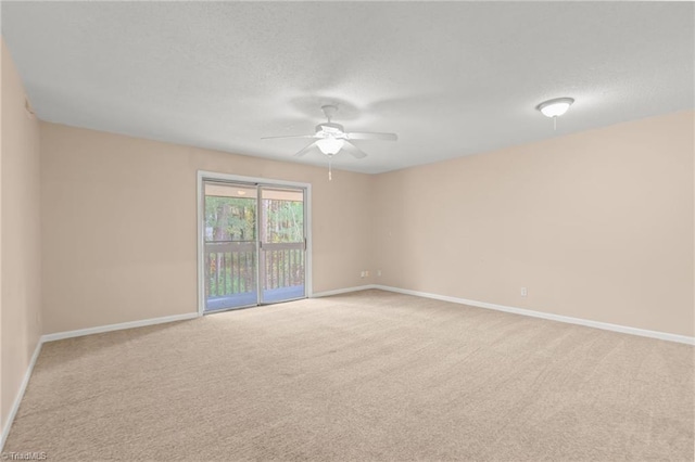 unfurnished room with a textured ceiling, light carpet, and ceiling fan