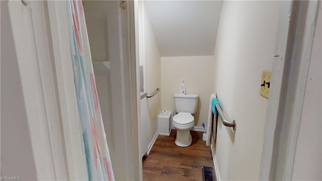 bathroom with toilet, wood finished floors, and baseboards