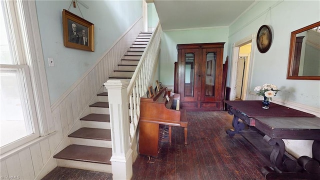 foyer entrance featuring stairway, hardwood / wood-style flooring, and ornamental molding