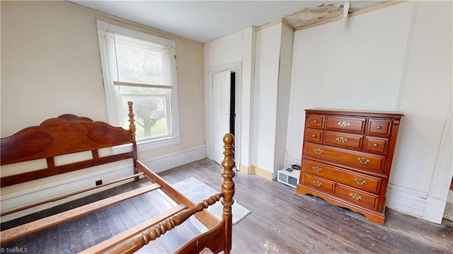 bedroom with wood finished floors and baseboards