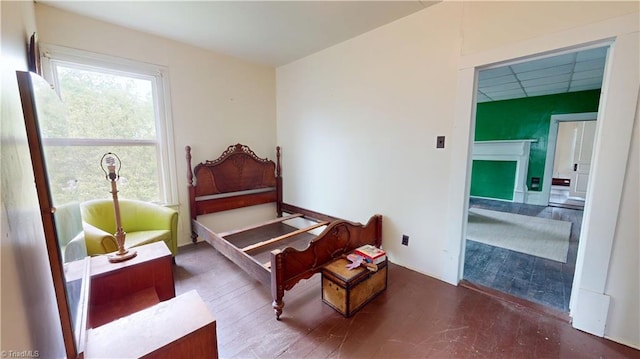 bedroom with wood finished floors and a fireplace