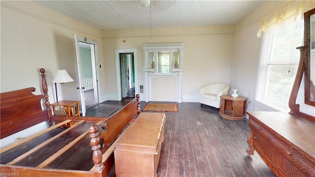 sitting room featuring dark wood-type flooring and wooden ceiling
