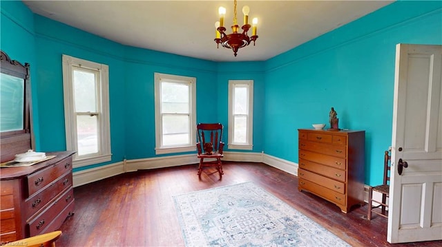 sitting room featuring a chandelier, hardwood / wood-style floors, plenty of natural light, and baseboards