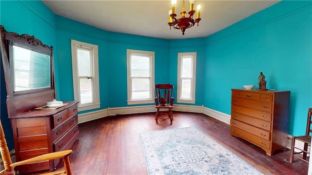 sitting room with a chandelier, dark wood-style floors, and baseboards