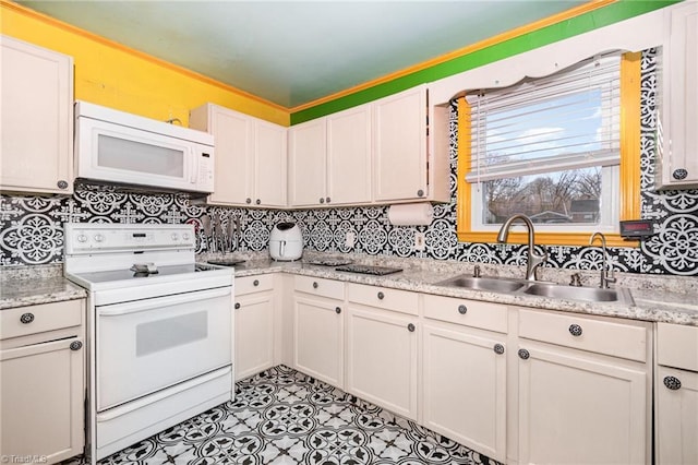 kitchen featuring light tile patterned floors, sink, white appliances, and white cabinets