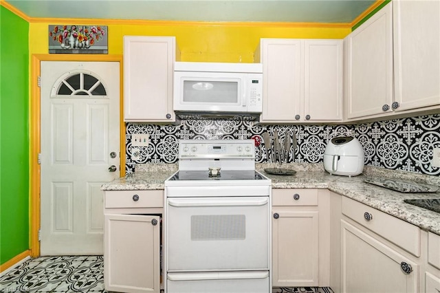 kitchen featuring white cabinets, white appliances, light stone countertops, and decorative backsplash