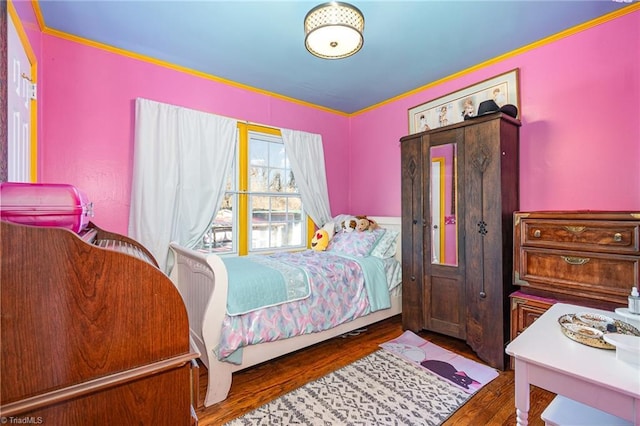 bedroom with dark hardwood / wood-style floors