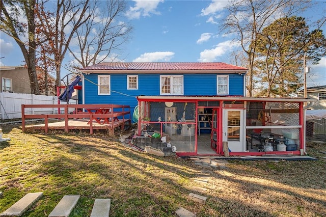 rear view of house with a yard