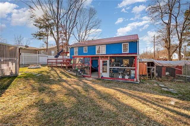 rear view of property featuring a lawn