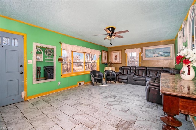 living room featuring a textured ceiling and ceiling fan