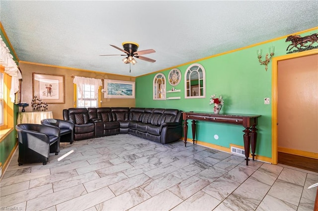 living room with a textured ceiling and ceiling fan