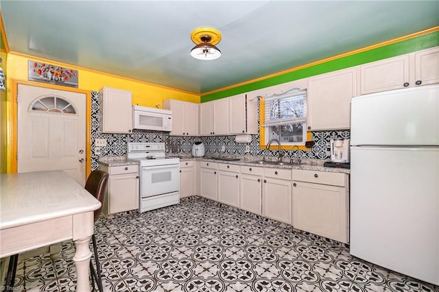 kitchen featuring sink, white appliances, white cabinetry, and light stone counters