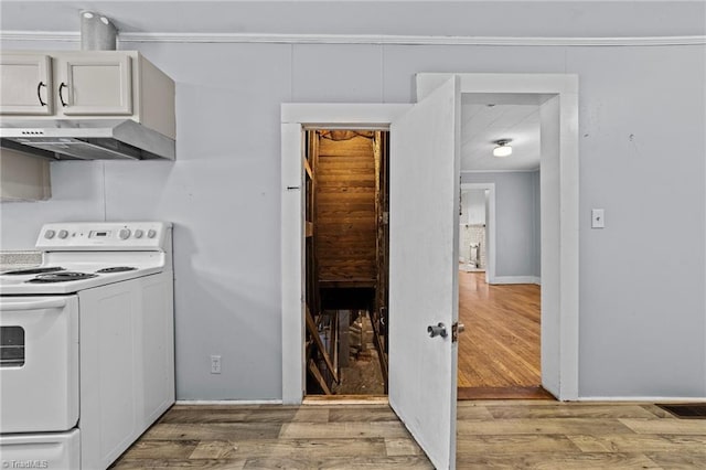 kitchen with white range with electric cooktop, light wood-style floors, white cabinets, under cabinet range hood, and baseboards