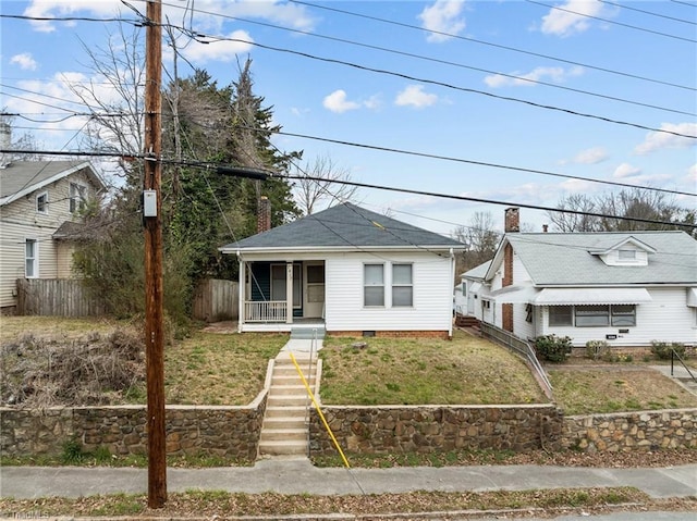 bungalow-style house with a chimney, stairway, crawl space, covered porch, and fence