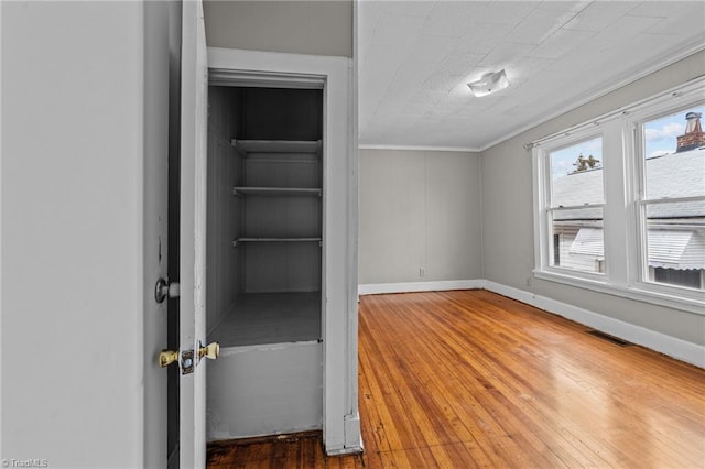 interior space featuring visible vents, baseboards, and wood finished floors