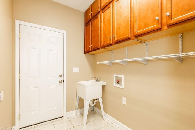 6402 Calvary Way, Thomasville, NC 27360 - laundry area with washer hookup, cabinet space, and light tile patterned floors