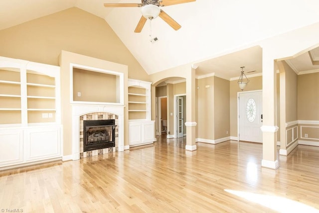 6402 Calvary Way, Thomasville, NC 27360 - unfurnished living room with ceiling fan, built in features, wood finished floors, arched walkways, and a fireplace