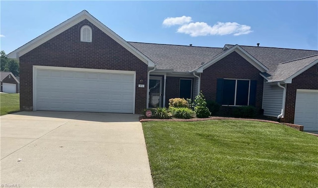 3027 Maple Ave Unit T1, Burlington, NC 27215 - ranch-style home with brick siding, a front yard, concrete driveway, a garage, and a shingled roof