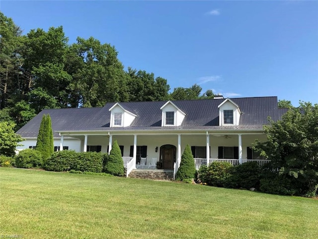 cape cod-style house featuring a front lawn and a porch