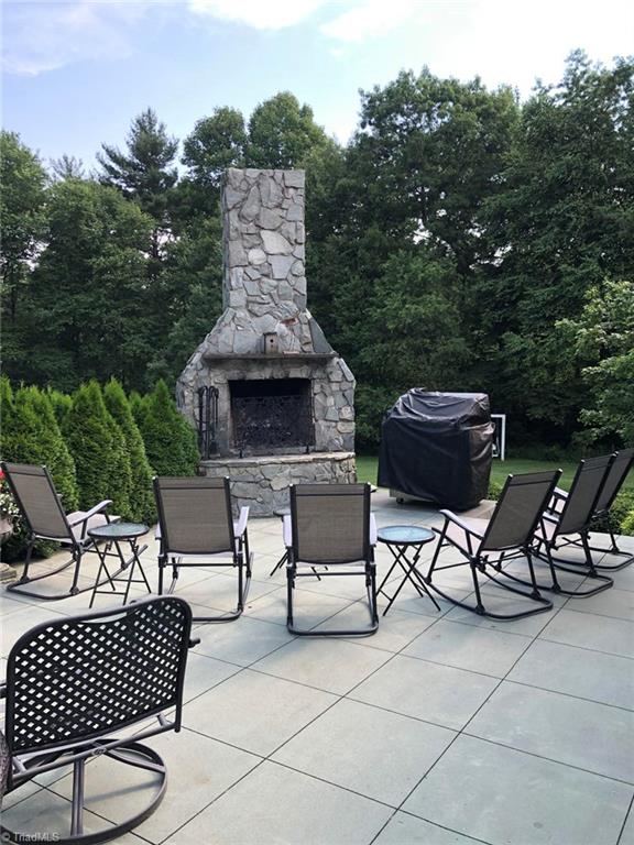 view of patio featuring an outdoor stone fireplace