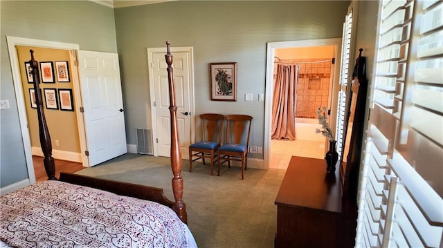 bedroom featuring a spacious closet, dark carpet, ensuite bathroom, and a closet