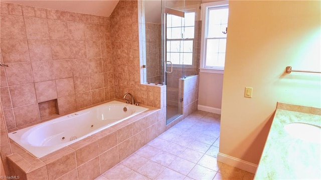 bathroom with tiled bath, tile walls, tile floors, and vanity