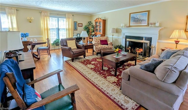 living room with ornamental molding and light hardwood / wood-style flooring