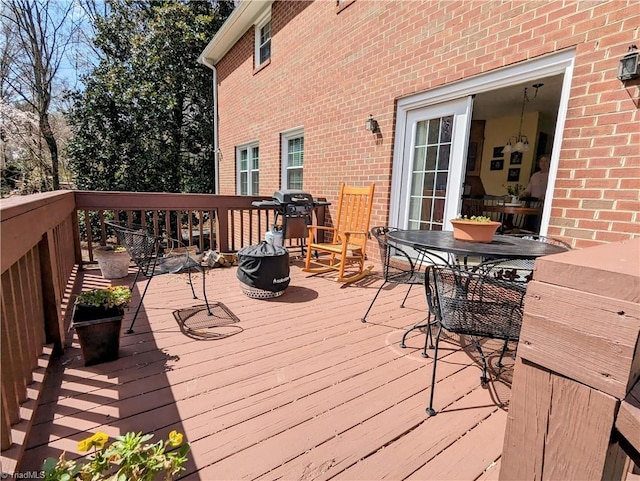 wooden deck with a grill