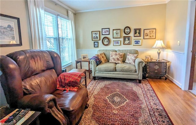 living area featuring hardwood / wood-style flooring and crown molding