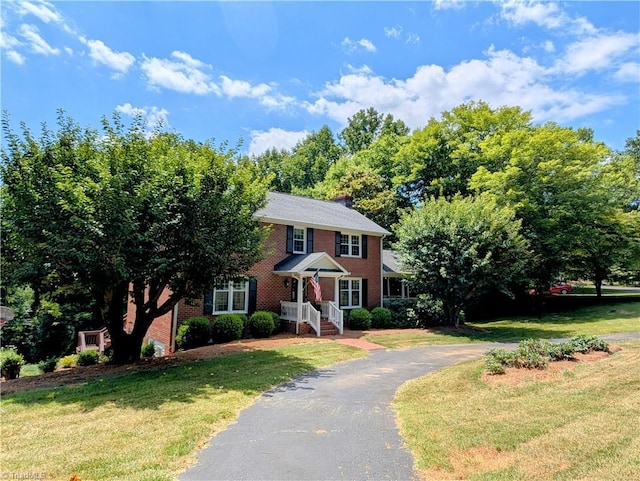 colonial home with a front lawn