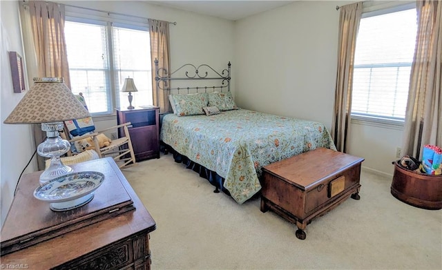 bedroom with carpet and multiple windows