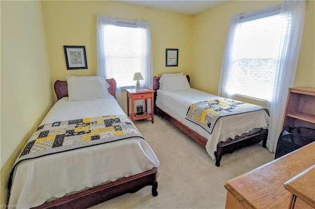 bedroom featuring multiple windows and light carpet