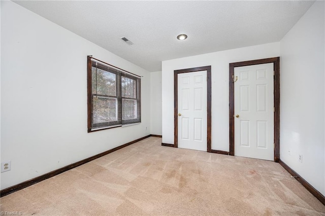 unfurnished bedroom featuring light colored carpet