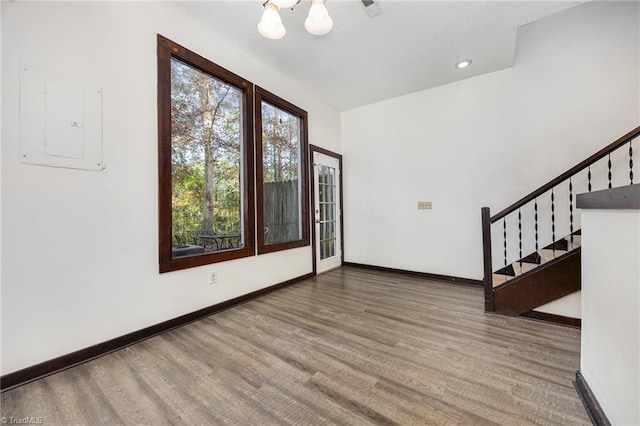 interior space with electric panel and wood-type flooring