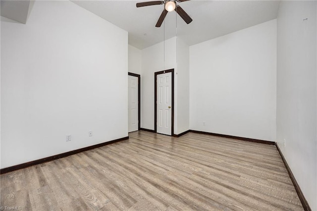 empty room featuring ceiling fan and light hardwood / wood-style flooring