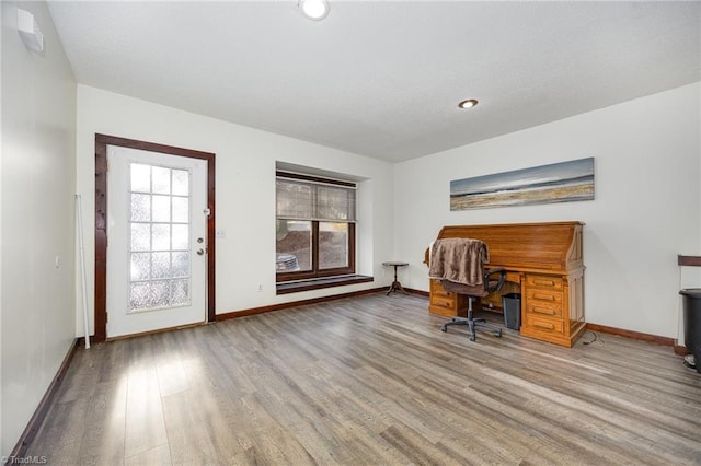 unfurnished office featuring hardwood / wood-style floors